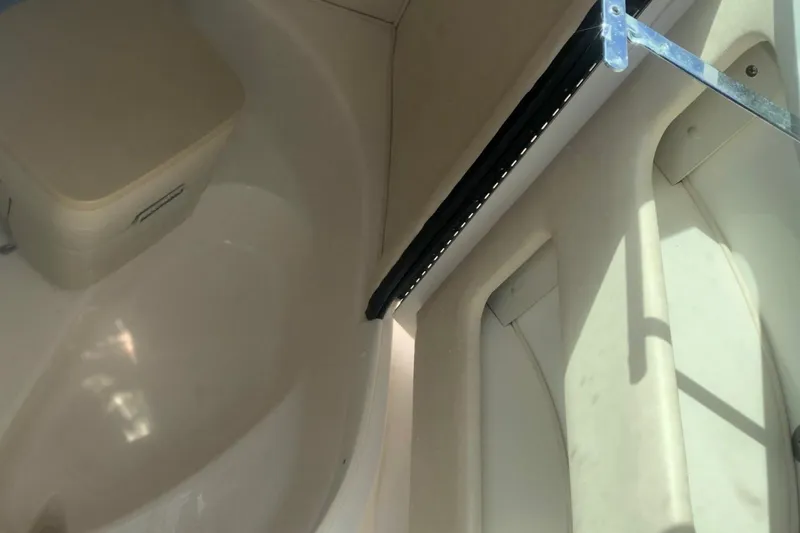 Slide: The Image of Interior of 2001 Sea Ray 280 boat, featuring seating and storage area. - 9