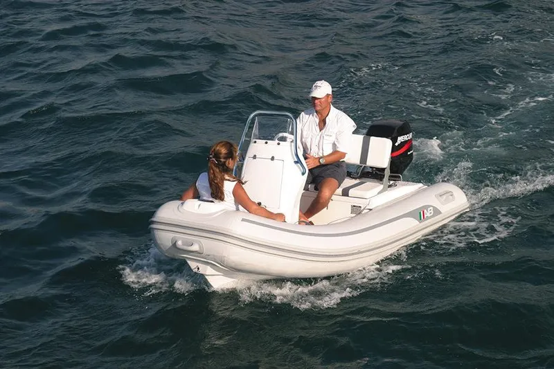 Slide: The Image of 2024 AB Inflatables 11 VST boat on water with two people. - 3