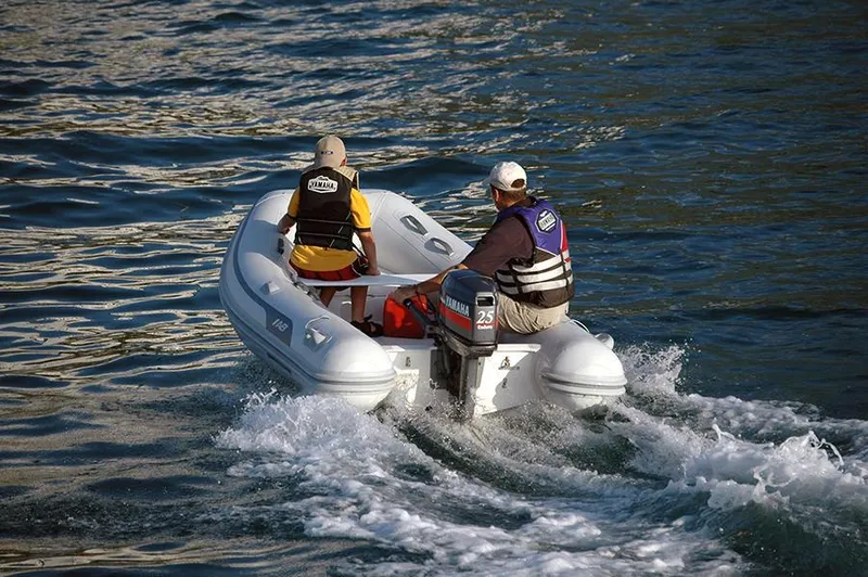 Slide: The Image of 2024 AB Inflatables 10 vs boat with two people on water. - 2