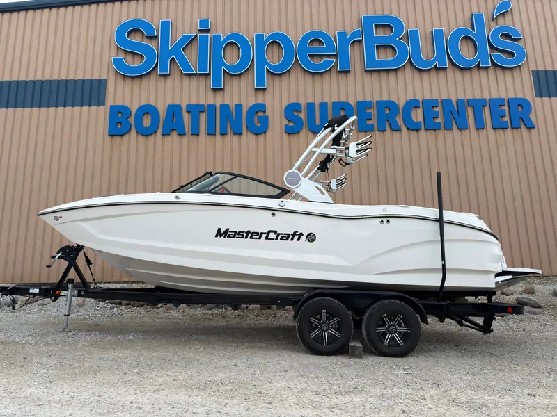 The Image of MasterCraft X22 2023 on a trailer in front of a boating center. - 0