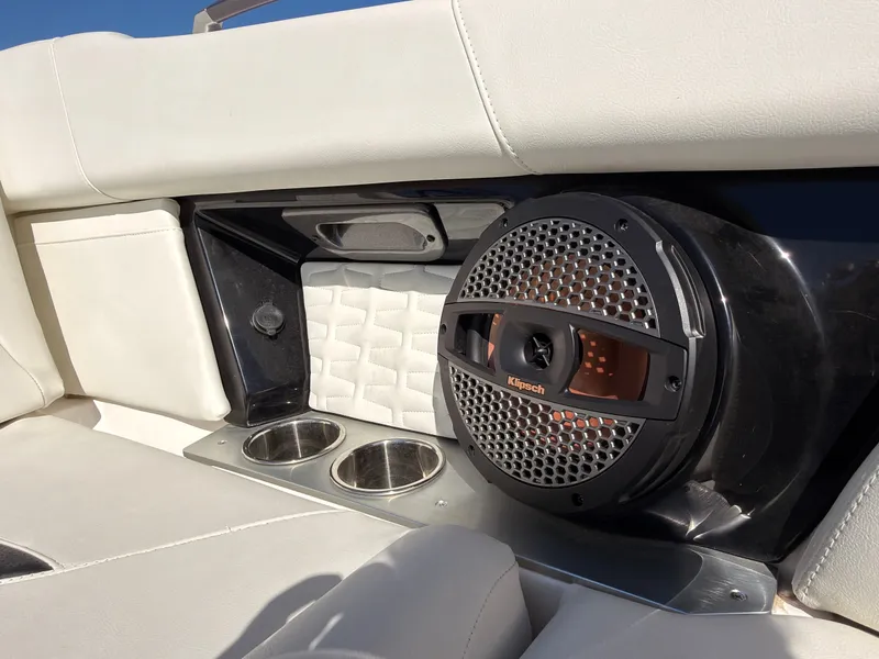 Slide: The Image of The image shows the interior of a 2023 MasterCraft X22 with white upholstery and a built-in speaker. - 45