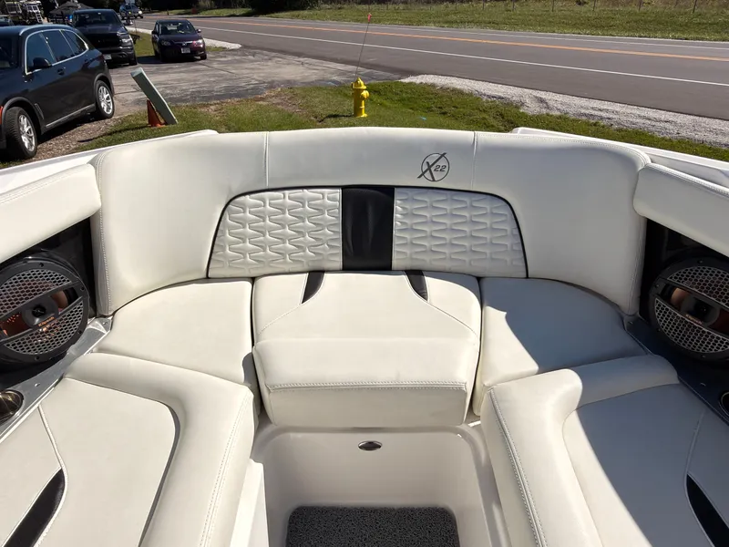 Slide: The Image of The image shows the interior of a 2023 MasterCraft X22 boat with white upholstery. - 46