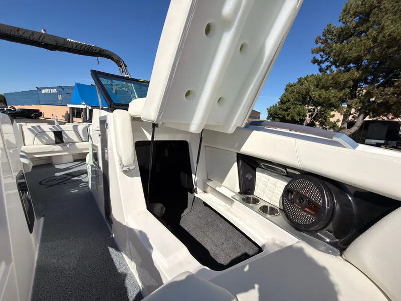 Slide: The Image of The image shows the interior of a 2023 MasterCraft X22 boat with white upholstery and speakers. - 44