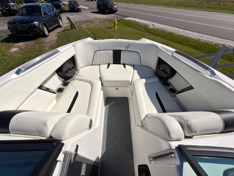 Slide: The Image of The image shows the bow of a 2023 MasterCraft X22 with luxurious white seating. - 42