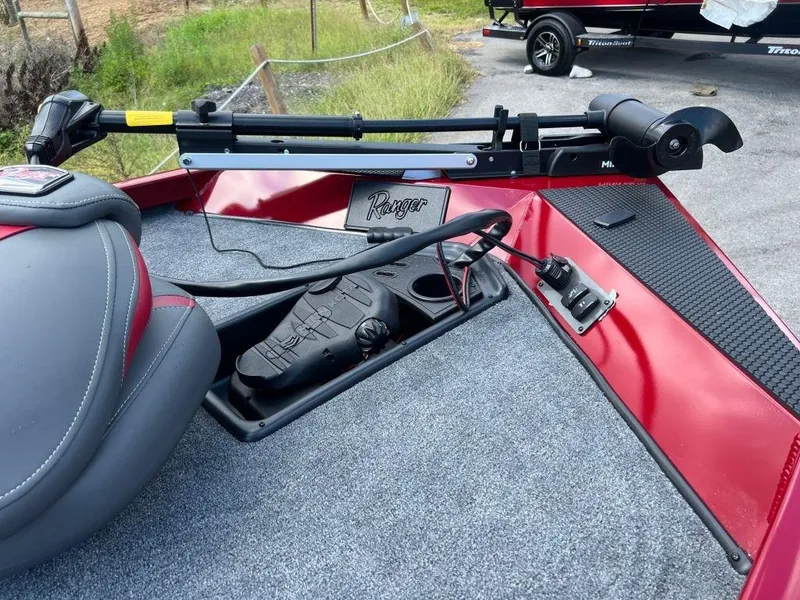 Slide: The Image of 2023 Ranger RT188 boat deck with trolling motor and seat, featuring red and gray design. - 7