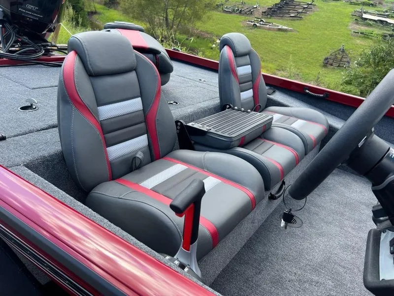 Slide: The Image of 2023 Ranger RT188 boat interior with gray and red seats, outdoor setting. - 9
