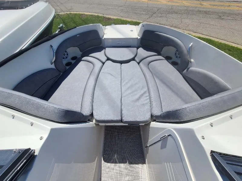 Slide: The Image of 2022 Stingray 215LR boat with spacious cushioned seating area. - 10