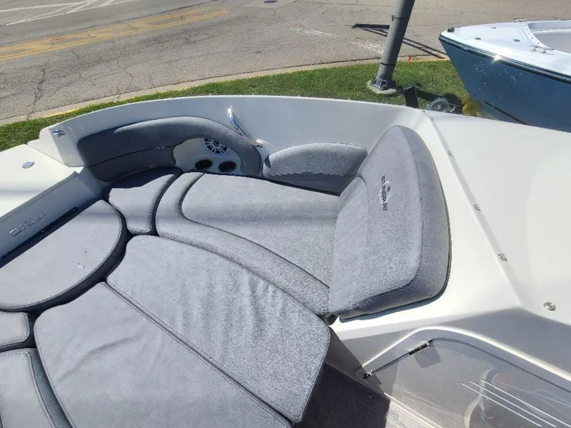 Slide: The Image of 2022 Stingray 215LR boat interior with gray cushioned seating. - 11