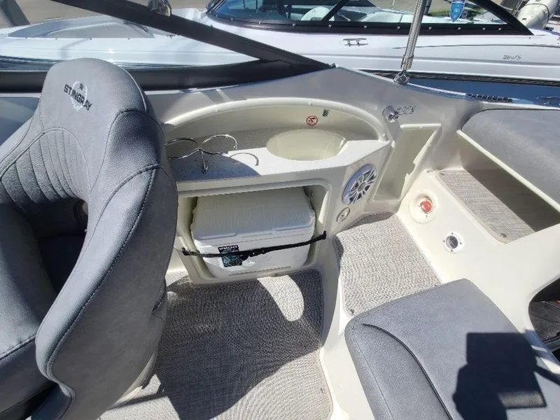 Slide: The Image of 2022 Stingray 215LR boat interior with storage compartment and seating. - 6