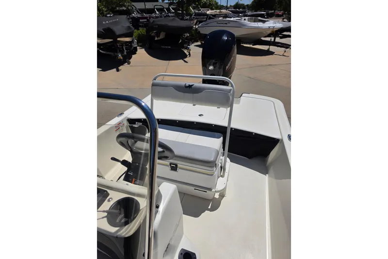 Slide: The Image of 2023 Mako Pro Skiff 17 CC boat interior with steering wheel and seating. - 8