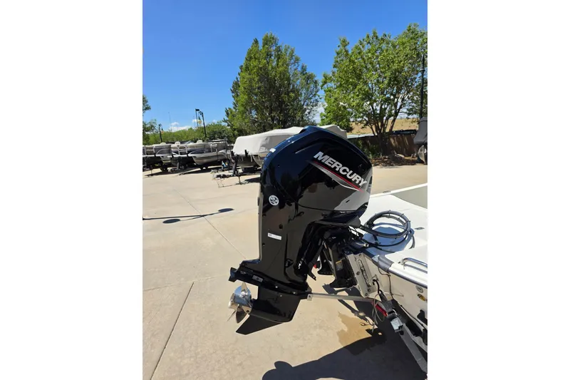 Slide: The Image of 2023 Mako Pro Skiff 17 CC with Mercury outboard motor in a sunny outdoor setting. - 7