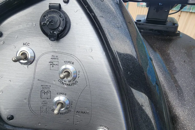 Slide: The Image of Control panel of 2023 Tracker Pro Team 190 TX boat with switches and 12V outlet. - 13