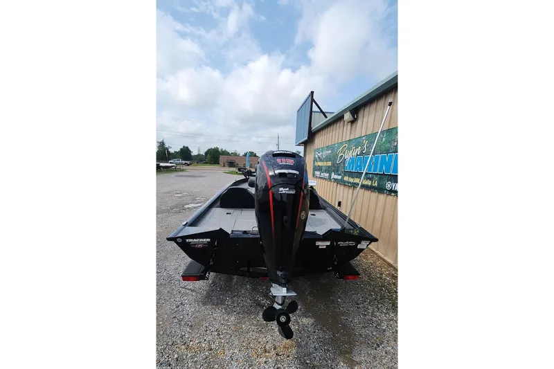 Slide: The Image of 2023 Tracker Pro Team 190 TX boat with outboard motor, parked outdoors. - 6