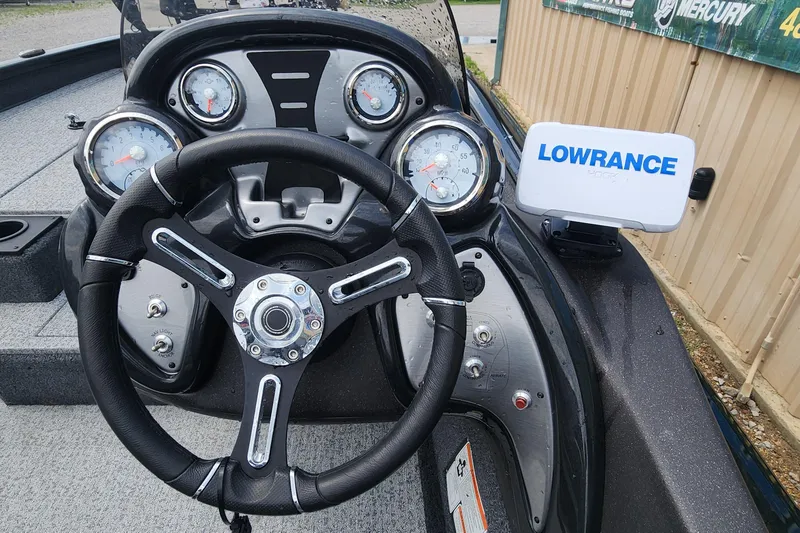 Slide: The Image of 2023 Tracker Pro Team 190 TX boat dashboard with steering wheel and Lowrance display. - 8