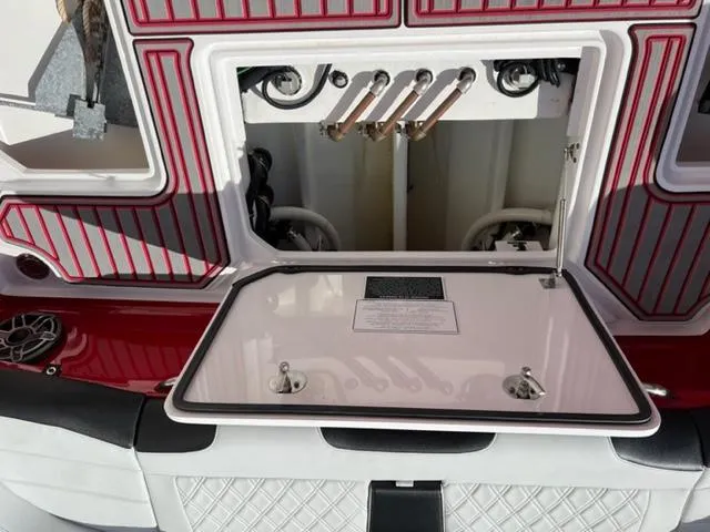 Slide: The Image of 2022 Nor-Tech 390 Sport Center Console boat interior with open storage compartment. - 10