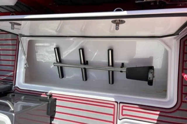 Slide: The Image of Open storage compartment on a 2022 Nor-Tech 390 Sport Center Console boat. - 12