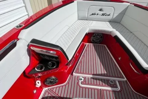 Slide: The Image of 2022 Nor-Tech 390 Sport Center Console boat interior with red and white seating. - 18