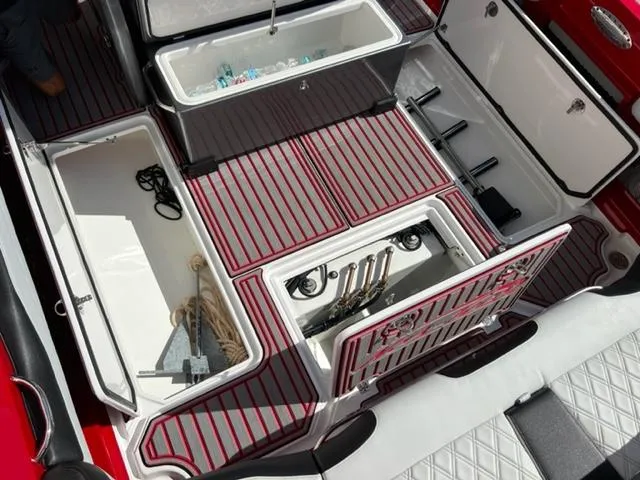 Slide: The Image of 2022 Nor-Tech 390 Sport Center Console storage compartments and fishing gear. - 20