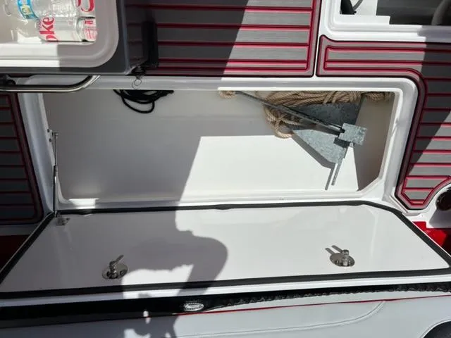 Slide: The Image of Storage compartment of 2022 Nor-Tech 390 Sport Center Console boat with anchor and rope. - 21