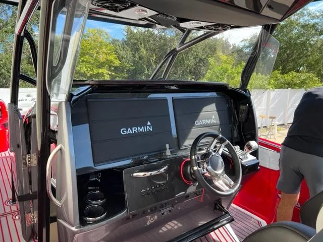 Slide: The Image of 2022 Nor-Tech 390 Sport Center Console helm with Garmin displays. - 5