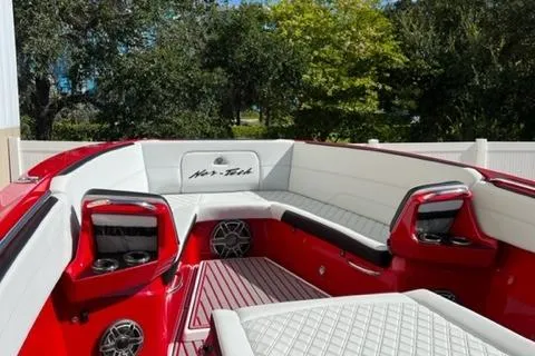 Slide: The Image of 2022 Nor-Tech 390 Sport Center Console boat with red and white interior. - 8