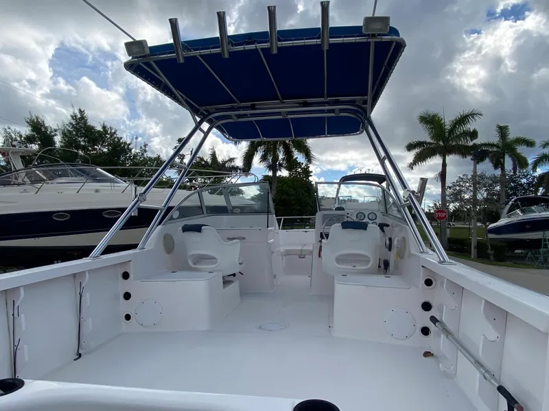 Slide: The Image of 2004 Pro-Line 22DC boat interior with seating and blue canopy. - 4