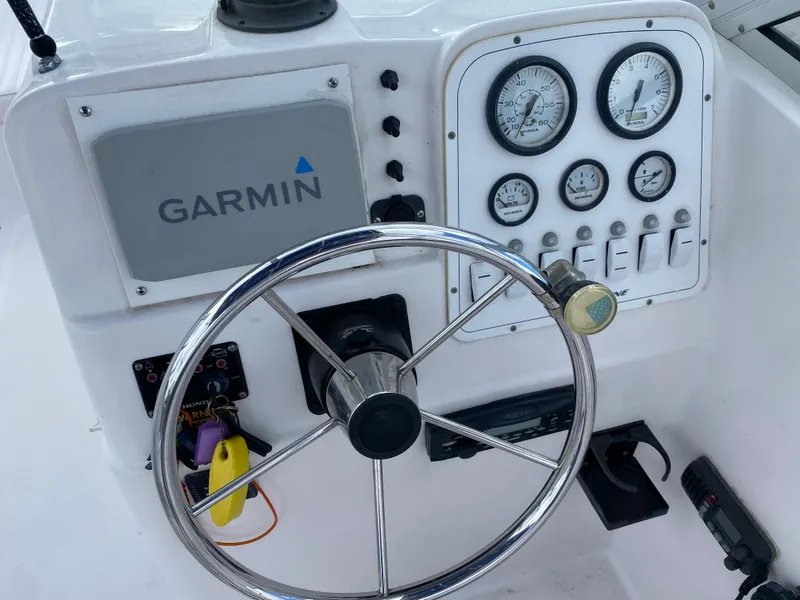 Slide: The Image of 2004 Pro-Line 22DC boat dashboard with Garmin navigation system and gauges. - 7