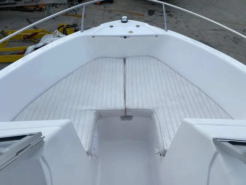 Slide: The Image of 2004 Pro-Line 22DC boat bow with white cushioned seating. - 8