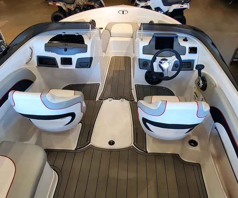 Slide: The Image of 2023 Tahoe 210 Si Limited boat interior with dual captain's chairs and modern dashboard. - 2