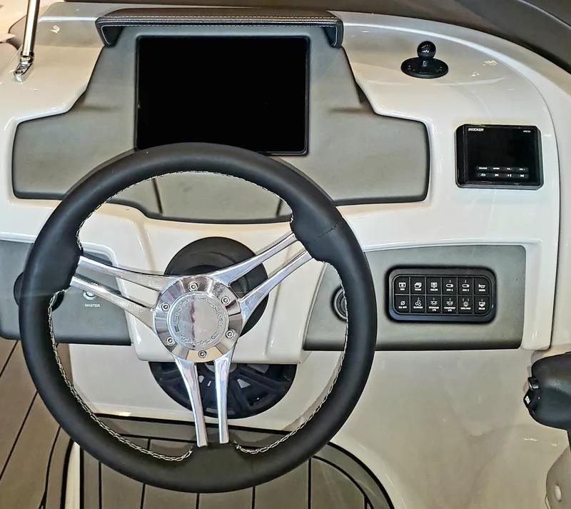 Slide: The Image of 2023 Tahoe 210 Si Limited boat dashboard with steering wheel and control panel. - 4
