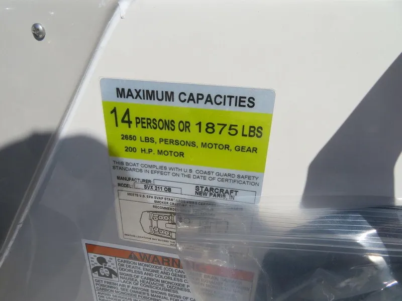 Slide: The Image of 2023 Starcraft SVX OB 211 OB capacity label: 14 persons or 1875 lbs, 200 HP motor. - 11