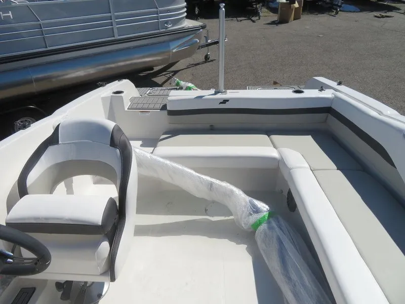 Slide: The Image of 2023 Starcraft SVX OB 211 OB boat interior with seating and steering wheel. - 12