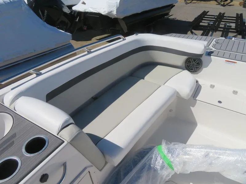 Slide: The Image of 2023 Starcraft SVX OB 211 OB boat interior with cushioned seating and cup holders. - 13