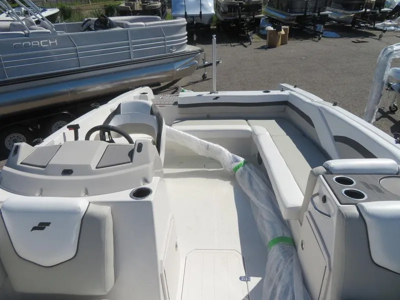 Slide: The Image of 2023 Starcraft SVX OB 211 OB boat interior with seating and steering console. - 16