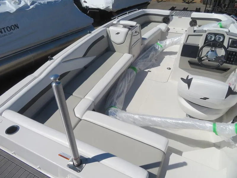 Slide: The Image of 2023 Starcraft SVX OB 211 OB boat interior with seating and control panel. - 4
