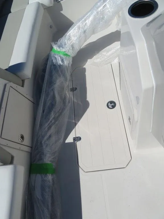 Slide: The Image of 2023 Starcraft SVX OB 211 OB boat interior with wrapped components and storage compartments. - 7