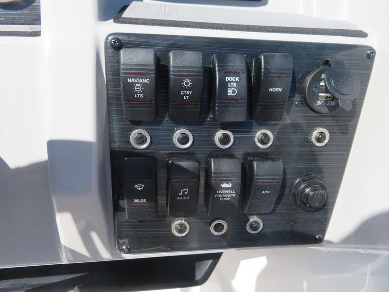 Slide: The Image of Control panel of 2023 Starcraft SVX OB 211 OB boat with various switches. - 9