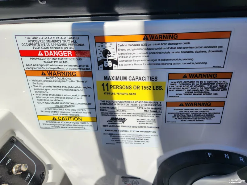 Slide: The Image of 2023 Bayliner DX2250 safety warnings and capacity limits displayed on dashboard. - 10