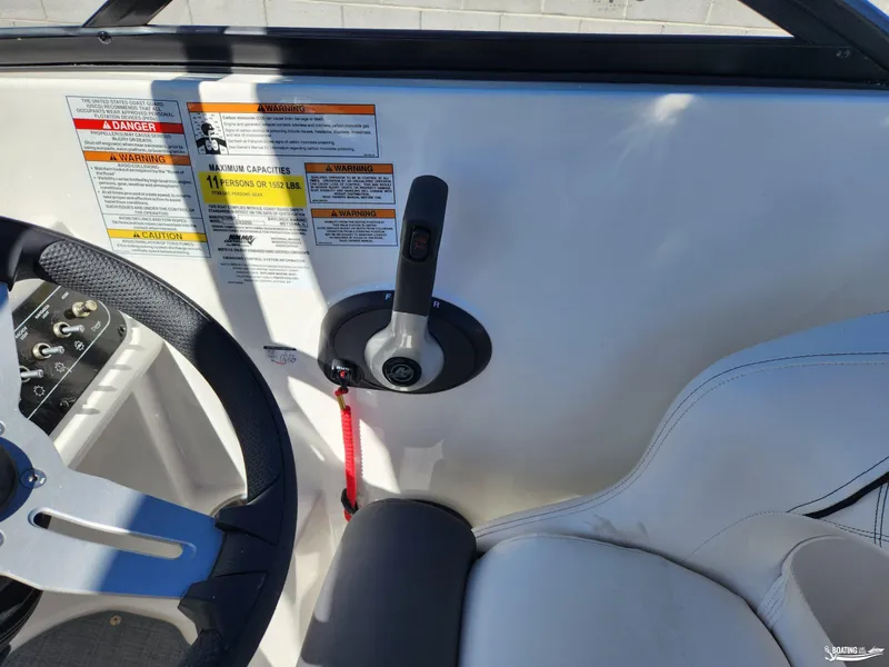 Slide: The Image of 2023 Bayliner DX2250 boat cockpit with steering wheel and control panel. - 11