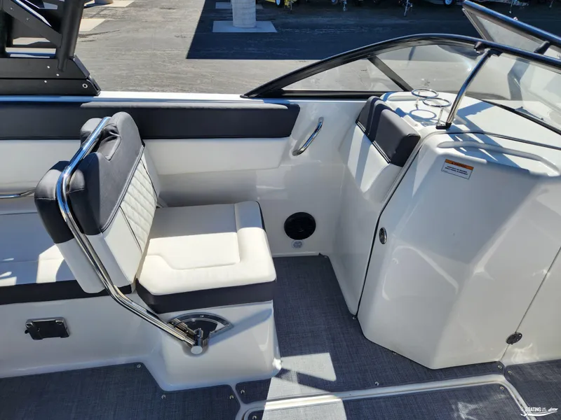 Slide: The Image of 2023 Bayliner DX2250 boat interior with seating and console, featuring modern design elements. - 15