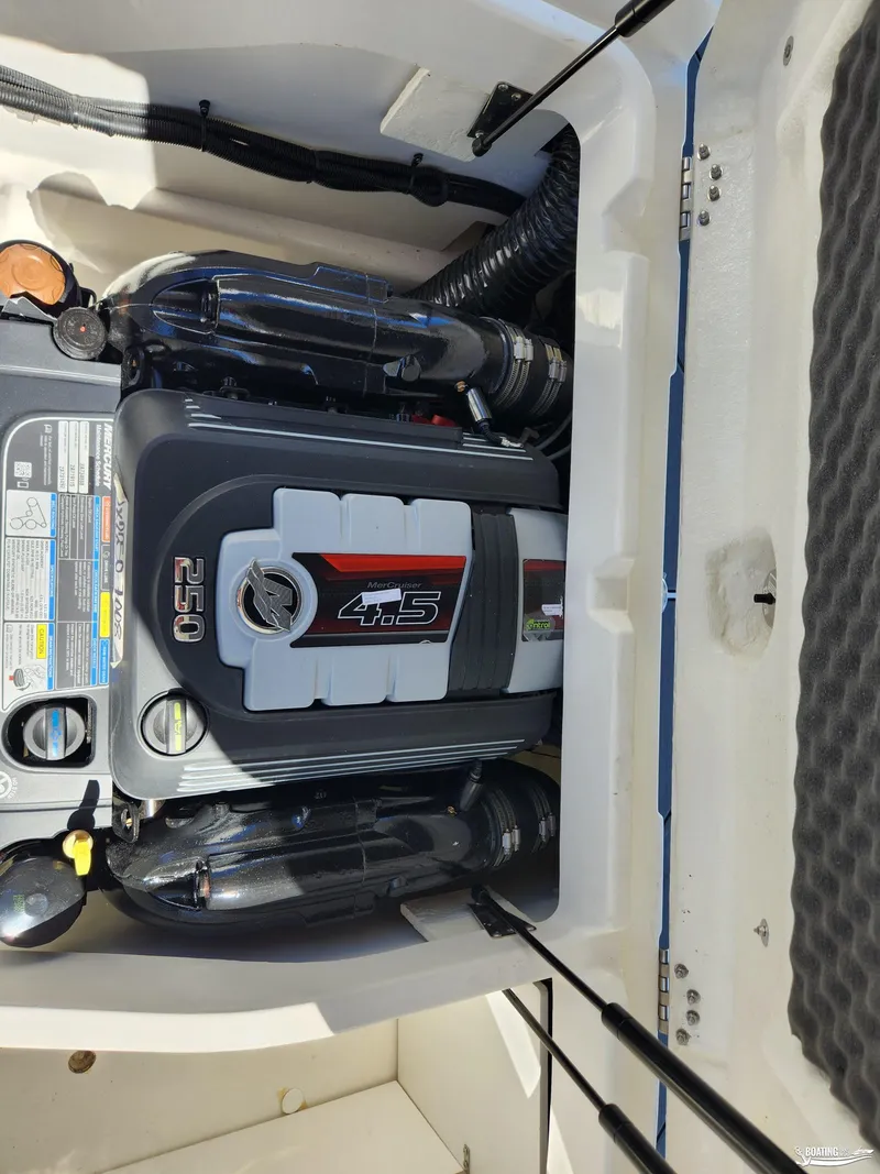 Slide: The Image of 2023 Bayliner DX2250 boat engine compartment with 4.5L 250 HP motor. - 18