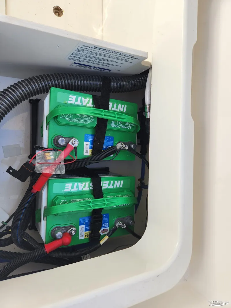 Slide: The Image of 2023 Bayliner DX2250 boat battery compartment with Interstate batteries. - 19