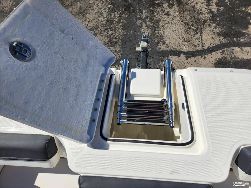 Slide: The Image of 2023 Bayliner DX2250 boat with open hatch and ladder on deck. - 22
