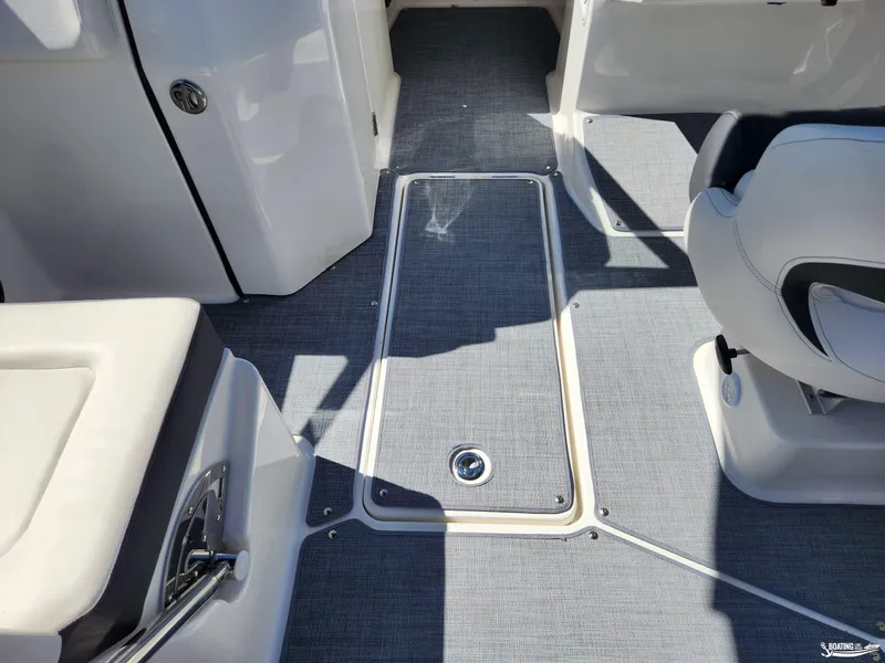 Slide: The Image of 2023 Bayliner DX2250 boat interior with gray flooring and seating. - 24