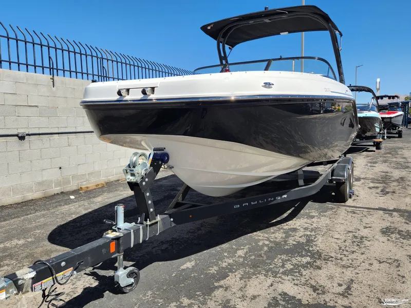 Slide: The Image of 2023 Bayliner DX2250 boat on trailer, parked outdoors. - 3