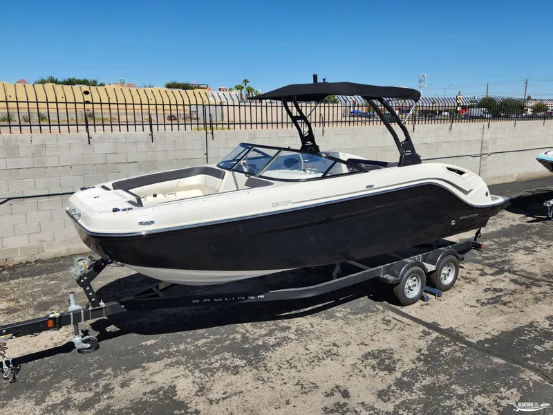 Slide: The Image of 2023 Bayliner DX2250 boat on trailer, parked outdoors. - 5