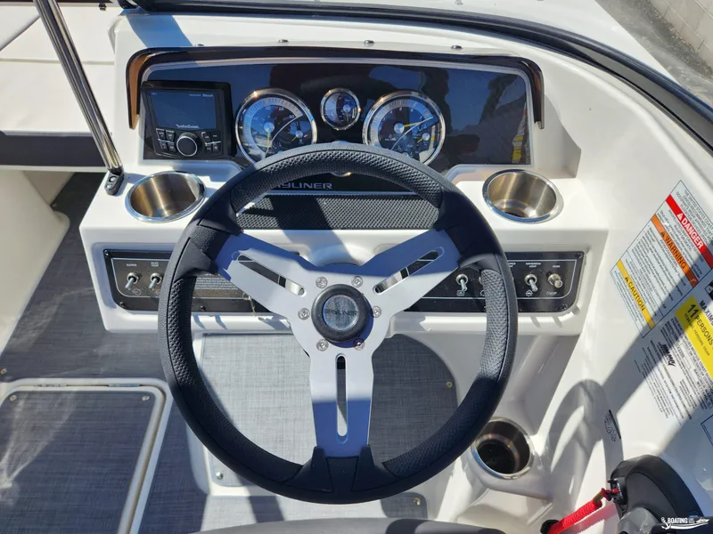 Slide: The Image of 2023 Bayliner DX2250 boat dashboard with steering wheel and instrument panel. - 8