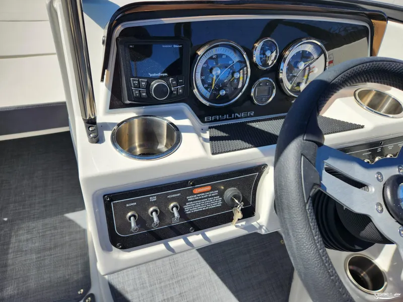 Slide: The Image of 2023 Bayliner DX2250 dashboard with steering wheel and control panel. - 9