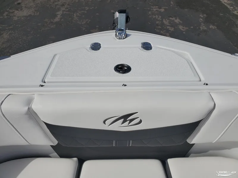 Slide: The Image of 2023 Monterey M22 boat interior with sleek white seating and logo detail. - 12