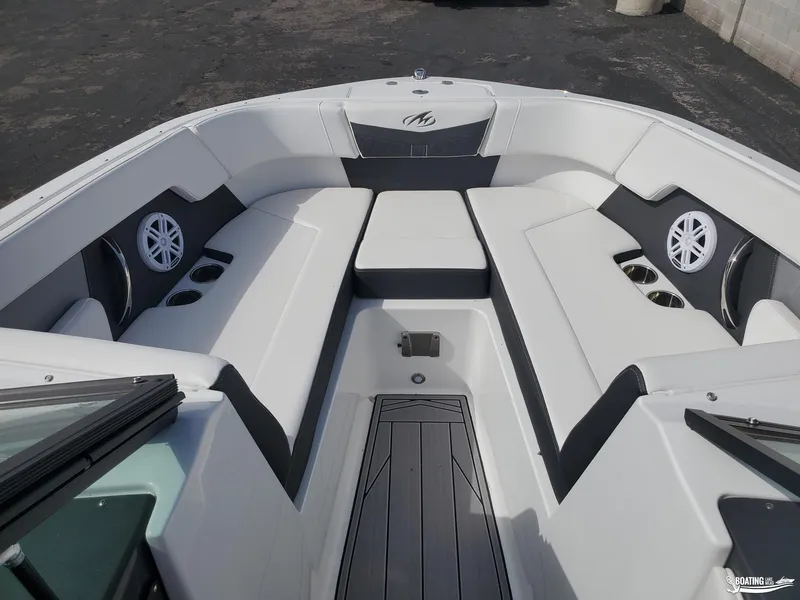Slide: The Image of 2023 Monterey M22 boat interior with white seating and cup holders. - 13